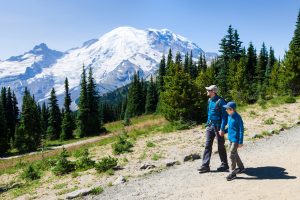 Finding ways to walk 8,000 to 10,000 steps a day is among the tips medical experts suggest for staying healthy. (Aleksei Potov/Adobe Stock) family of two, father and son, hiking and enjoying mount rainier national park in washington state, usa, healthy active lifestyle concept