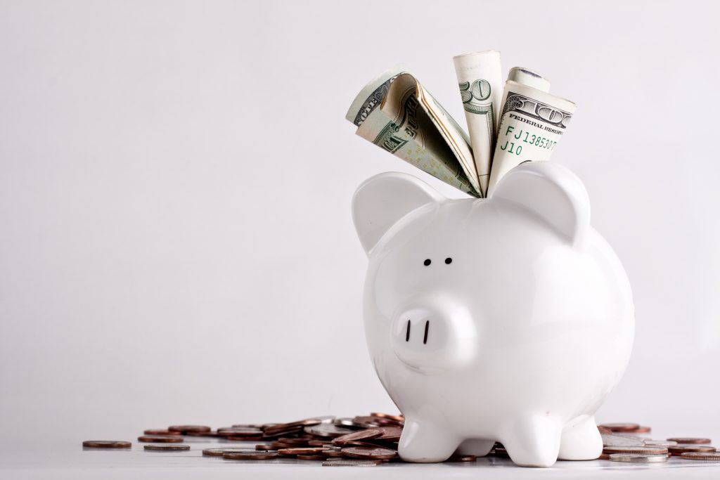 One stuffed, overfilled full piggy bank