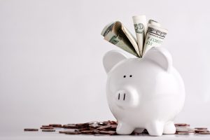 One stuffed, overfilled full piggy bank