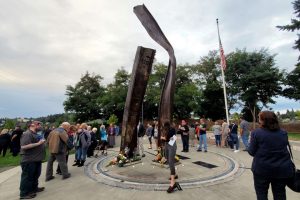 People gather at Bremerton's 9/11 memorial, which features bent metal beams from the fallen Twin Towers, after Saturday's ceremony. People gathered at Bremerton 9/11 memorial