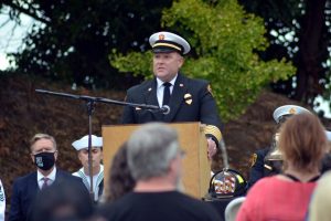 South Kitsap Fire and Rescue Chief Jeff Faucett speaks at Saturday's 9/11 memorial ceremony (Steven Wyble/Kitsap Scene). South Kitsap Fire & Rescue Chief Jeff Faucett speaking into microphone