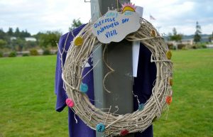 A wreath with buttons displaying the names of loved ones lost to overdoses