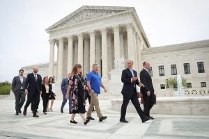 Former Bremerton High School assistant football coach Joe Kennedy holds hands with his wife Denise as he walks in front of the U.S. Supreme Court with members of his legal team after his case, Kennedy vs. Bremerton School District, was argued before the Supreme Court on April 25, 2022 in Washington, DC. Kennedy was terminated from his job by Bremerton public school officials in 2015 after refusing to stop his on-field prayers after football games. (Photo by Win McNamee/Getty Images) Former Bremerton High School assistant football coach Joe Kennedy holds hands with his wife Denise as he walks in front of the U.S. Supreme Court with members of his legal team after his case, Kennedy vs. Bremerton School District, was argued before the Supreme Court on April 25, 2022 in Washington, DC. Kennedy was terminated from his job by Bremerton public school officials in 2015 after refusing to stop his on-field prayers after football games.