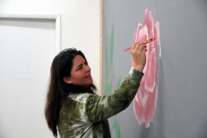 Danielle Rimbert paints a wall at her Callow Avenue studio (Steven Wyble/Kitsap Scene) Danielle Rimbert paints a wall at her Callow Avenue studio