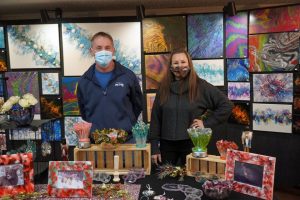 Pat and Kolyne Forro pose with their epoxy art and acrylic paintings at the Bainbridge Island Studio Tour (Photo by Kitsap Scene) Pat and Kolyne Forro pose with their epoxy art and acrylic paintings at the Bainbridge Island Studio Tour