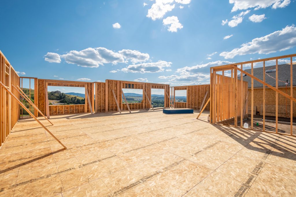 A new construction home being framed on a hillside with a view overlooking Spokane Valley, Washington A new construction home being framed on a hillside with a view overlooking Spokane Valley, Washington