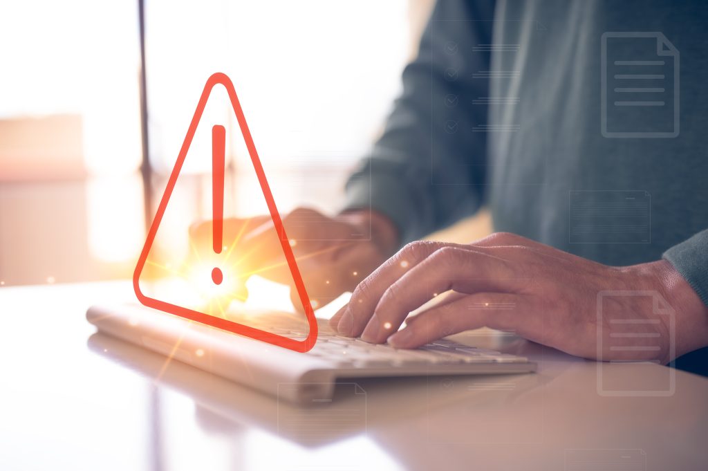 internet network security concept, man typing on keyboard with triangle warning sign developer with triangle caution warning sign for notification error and maintenance, e-document data protection