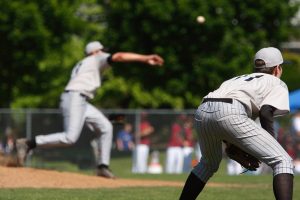third basemen getting ready as the pitcher throws the ball