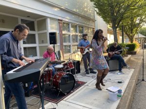 Francesco Crosara, Glenn Young, Derick Polk, Eugenie Jones and Dean Kelly performing at a past Make Music Day event. Photo Courtesy of Music Discovery Center and taken by Mike Barnet. Musicians performing live on a sidewalk in downtown Bremerton, WA.