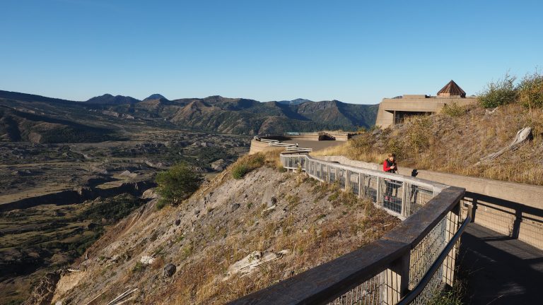 Woman in red fleece enjoys the view of Mount Saint Helens, Washington, from the Johnston Ridge Observatory's trail.