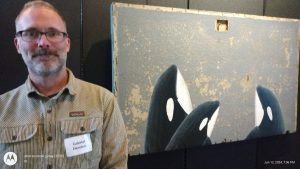 Artist Gabriel Newton used acrylic on found wood to paint Southern Resident orcas, which feed in the Salish Sea.