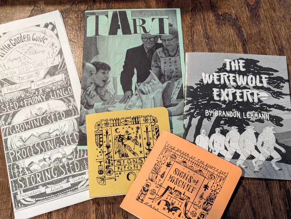A display of zines arranged on a tabletop